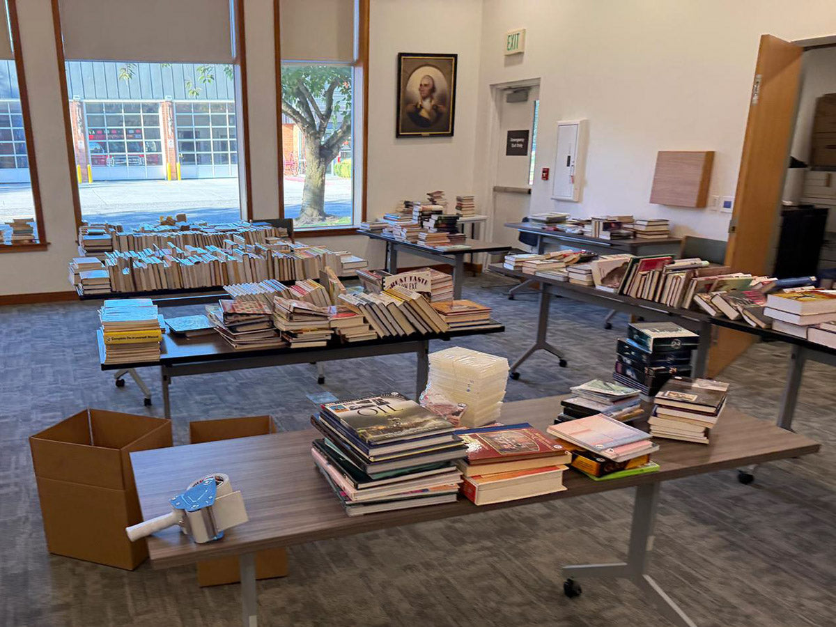 Mixed collection of older and modern used books on a bookshelf